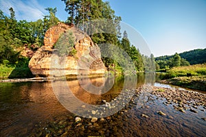 water stream in river of Amata in Latvia with sandstone cliffs