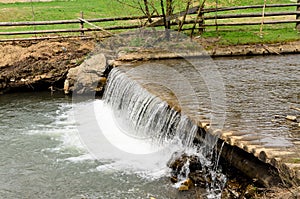 Water in a stream running over a weir