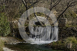 Water streams, rocks, trees and beatiful sky.Hoyo de Manzanares, Madrid, Spain.