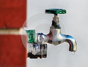 Water supply, outdoor garden faucet with green handle