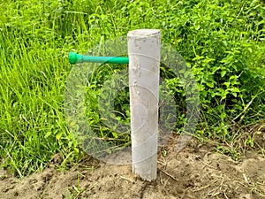 water supply piped and white post green nature