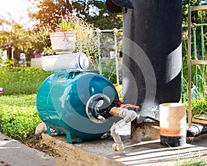 Water supply system from a well in a country house. New water filter. Hydraulic accumulator for storing water volume