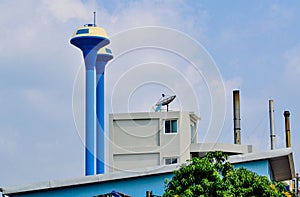 Water supply tank in factory of thailand on blue sky background.