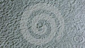 Water surface with circles of raindrops