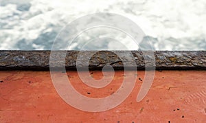 Water surface with ripples and orange color wood
