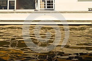 Water surface with ripples and part of a ship. water texture background