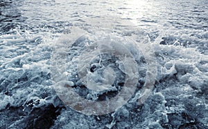 Water surface with ripples and sunlight reflections