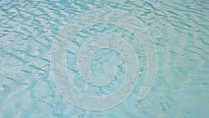 Water surface texture, Slow motion looping clean swimming pool ripples and wave, Refraction of sunlight top view texture