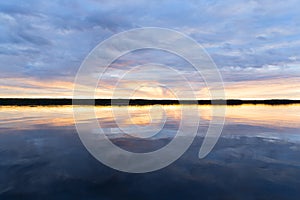 Water surface. View of a Sunset sky background. Dramatic gold sunset sky with evening sky clouds over the sea. View of a Crystal c