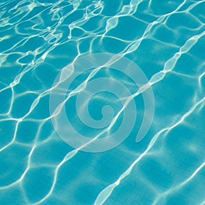 Water in a swimming pool creates a pattern of light and shadow on the