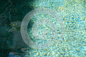 Water in swimming pool reflecting sunshine