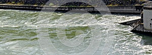 Water swirls behind hydroelectric power plant