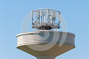 Water tank tower surmounted with a telephone repeater antennas