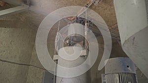 Water tanks on concrete mixing unit at factory. Camera moves up and down along industrial equipment at cement production