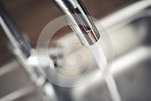 Water tap , faucet. Flow water in bathroom with sink. Modern clean hause. Backround hygiene.