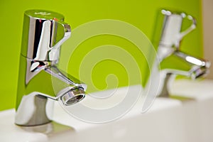 Water tap with a fresh coloured green background