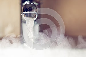 Water tap with hot water steam photo