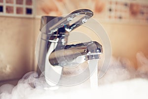 Water tap with hot water steam photo
