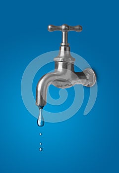 Water tap leaking drop of water - water conservation or saving concept