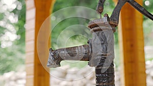 Water tap, outdoors in the nature, representing shortage of water. Water stand in the countryside. Water is dripping