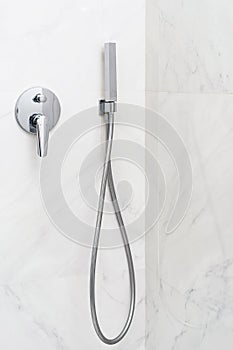 Water tap with shower head in bathroom
