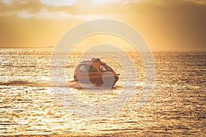 Water Taxi capsule in the sea during the sunset