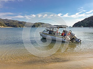 A water taxi picking up people from the beach at Watering Cove, Able Tasman National Park