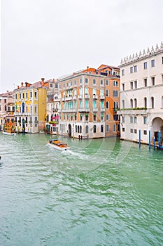 Water taxis/ taxicabs sailing on water between buildings in the Grand Canal, Venice, Italy