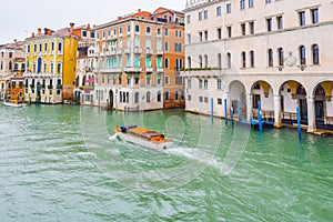 Water taxis/ taxicabs sailing on water between buildings in the Grand Canal, Venice, Italy