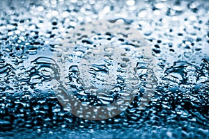 Water texture abstract background, aqua drops on blue glass as science macro element, rainy weather and nature surface art