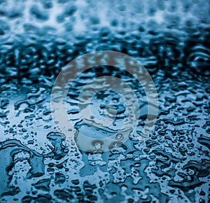 Water texture abstract background, aqua drops on blue glass as science macro element, rainy weather and nature surface art