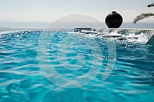 Water texture, infinity swimming pool. Luxury vacation and recreation concept