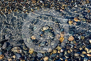 Water at tideline on a rocky beach, as a nature background, Semiahmoo Park, Washington State