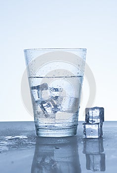 Water to drink a glass with coldness Ice on a table isolated