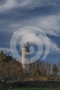 Water tower on hill over Trebic town in Moravia region in sunset evening