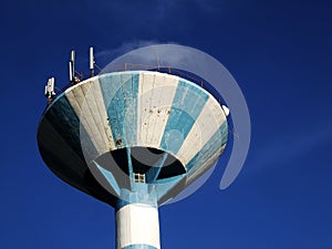 Water tower in perspective with antennas