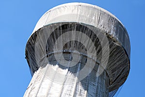 Water tower surrounded by a protective net photo