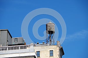 Water tower with urban sky