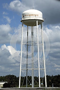 A water tower wiith an atenna on top