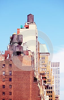 Water towers on New York buildings, color toning applied, USA