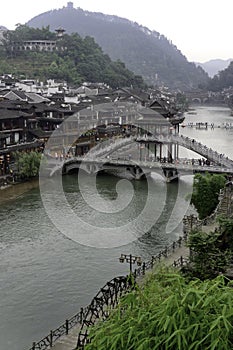 Water town, Fenghuang Ancient City, arches the Tuo Jiang River by way of The Nanhua Bridge, which is designed in traditional