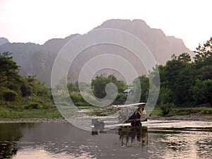 Water tractor vang vieng river laos photo