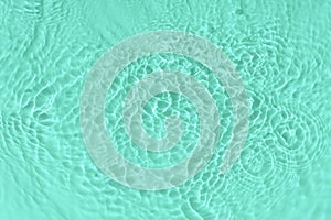 Water tranquil ripple background. Water texture, circles and bubbles on a liquid blue surface. Cosmetic products and