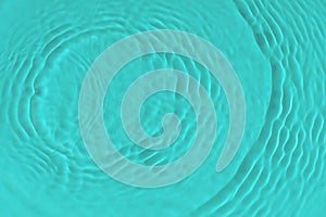 Water tranquil ripple background. Water texture, circles and bubbles on a liquid blue surface. Cosmetic products and