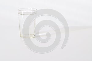 Water in transparent glass on gray background. fresh drink water on table