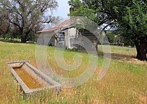 Water trough with old house
