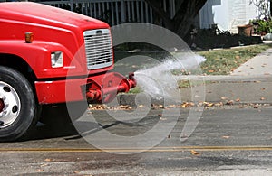 Water truck cleaning street