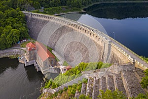 Water turbines are producing clean electricity at power plant in Pilchowice power plant. Drone shot of stone river dam