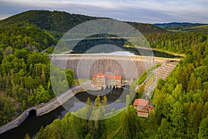 Water turbines are producing clean electricity at power plant in Pilchowice power plant. River dam and mountain