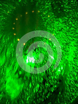 Water under glass in green light as a background